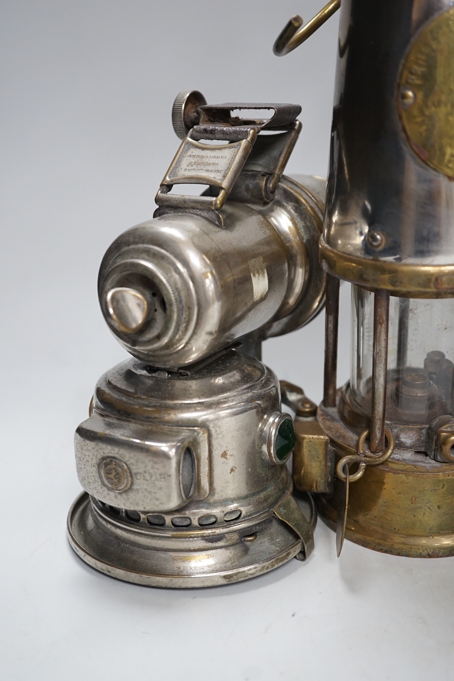 A miner's lamp stamped Seaham, and two Lucas road lamps and a H & B side lamp, No. 1001, largest 30cms high